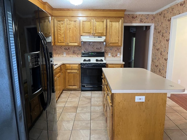 kitchen featuring light tile patterned floors, a kitchen island, a textured ceiling, black appliances, and crown molding