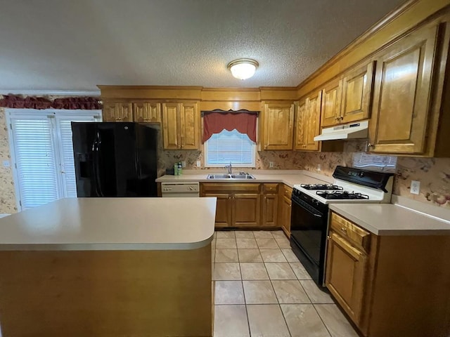 kitchen featuring light tile patterned floors, a textured ceiling, sink, and black appliances