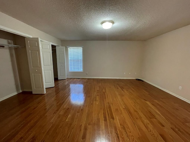 unfurnished bedroom with a textured ceiling and hardwood / wood-style floors