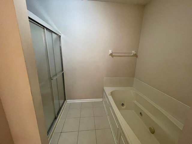 bathroom with independent shower and bath and tile patterned floors