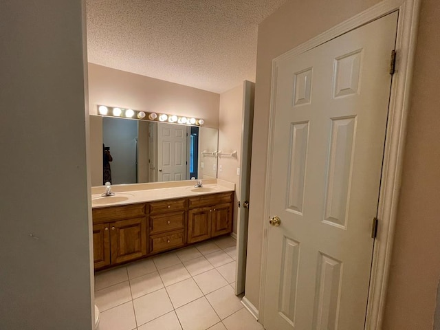 bathroom with vanity, tile patterned flooring, and a textured ceiling