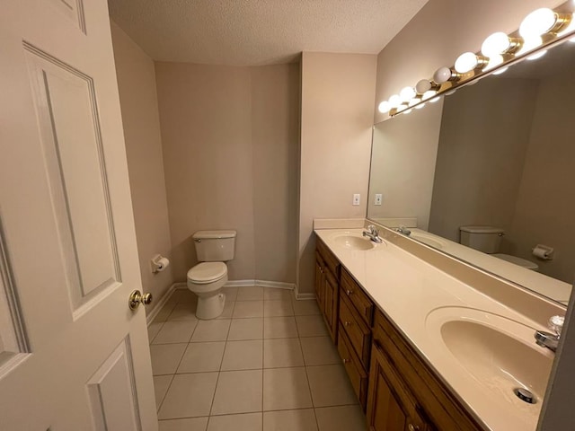 bathroom featuring a textured ceiling, tile patterned floors, vanity, and toilet