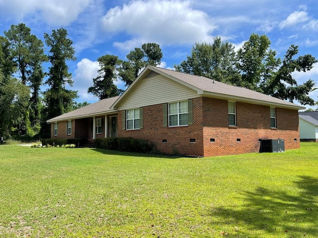 view of front of house with cooling unit and a front lawn