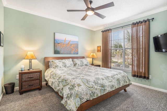 bedroom with ceiling fan, ornamental molding, a textured ceiling, and dark colored carpet