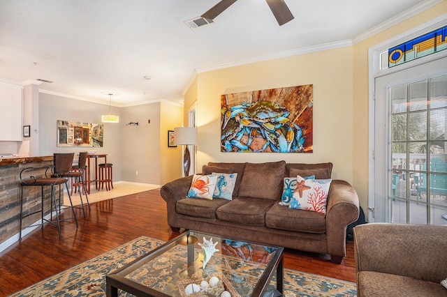 living room featuring ornamental molding, ceiling fan, and dark hardwood / wood-style flooring