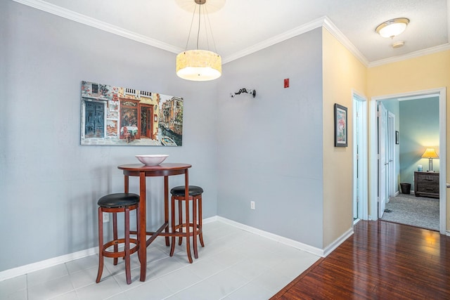 dining room featuring hardwood / wood-style flooring and ornamental molding