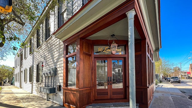 view of exterior entry featuring french doors