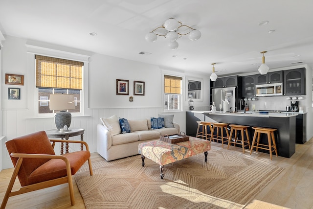 95 Line St, Charleston, SC 29403 - living room with light wood finished floors, wainscoting, visible vents, and recessed lighting
