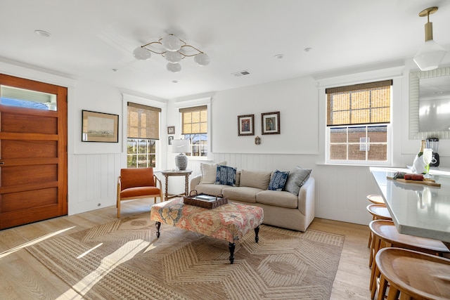 95 Line St, Charleston, SC 29403 - living area with light wood-type flooring, wainscoting, and visible vents