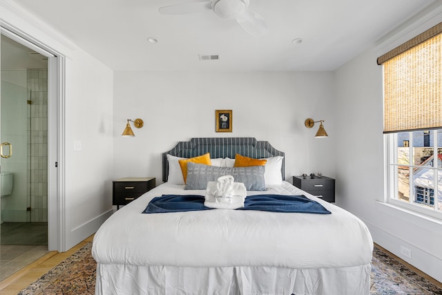 95 Line St, Charleston, SC 29403 - bedroom with visible vents, baseboards, a ceiling fan, ensuite bath, and wood finished floors