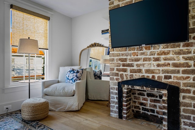 95 Line St, Charleston, SC 29403 - living area featuring a brick fireplace and wood finished floors