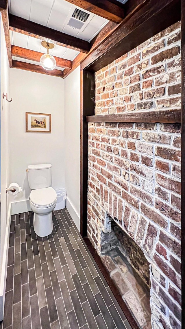 95 Line St, Charleston, SC 29403 - bathroom featuring beam ceiling, baseboards, toilet, and wood finished floors