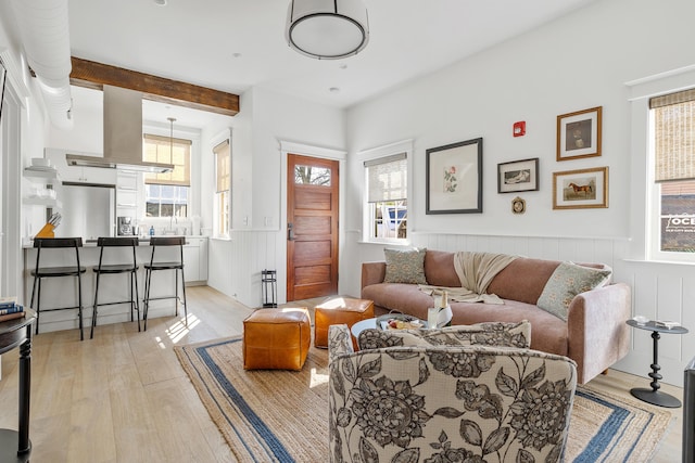 95 Line St, Charleston, SC 29403 - living area with light wood-type flooring and a wainscoted wall