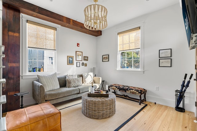 95 Line St, Charleston, SC 29403 - living area featuring a chandelier, baseboards, beam ceiling, and light wood-style floors
