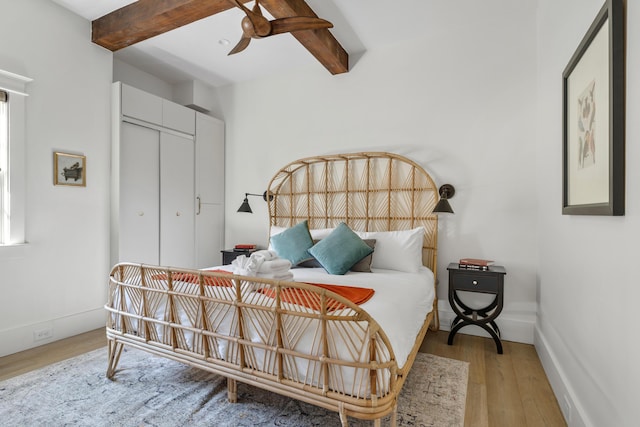 95 Line St, Charleston, SC 29403 - bedroom featuring ceiling fan, wood finished floors, baseboards, a closet, and beam ceiling