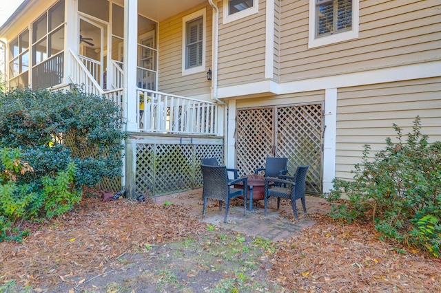 view of patio featuring a sunroom and an outdoor fire pit