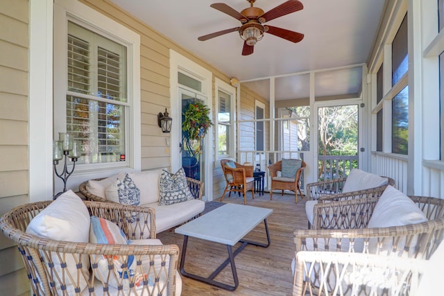 sunroom / solarium featuring a wealth of natural light and ceiling fan