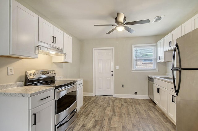 1554 Orange Grove Rd Unit A & B, Charleston, SC 29407 - kitchen with stainless steel appliances, under cabinet range hood, a ceiling fan, light countertops, and light wood finished floors