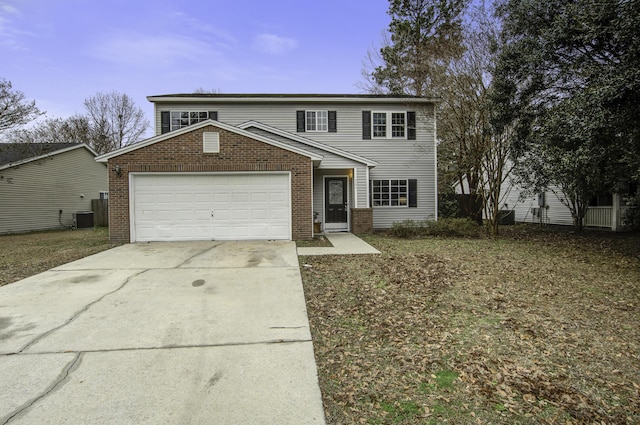 front of property featuring cooling unit and a garage