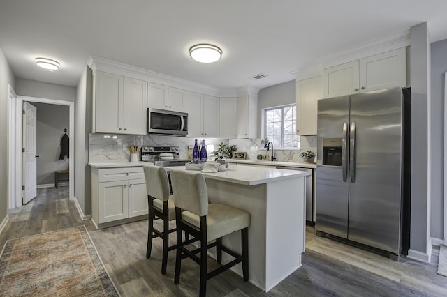 kitchen featuring white cabinets, dark wood-type flooring, and appliances with stainless steel finishes