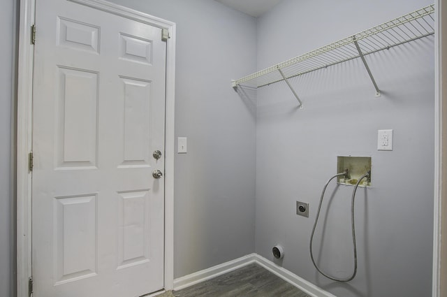 laundry room with electric dryer hookup, washer hookup, and dark wood-type flooring