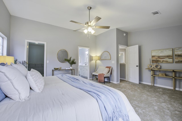 bedroom featuring a closet, ceiling fan, carpet flooring, ensuite bathroom, and lofted ceiling