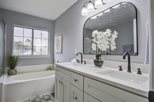 bathroom with tiled bath and vanity