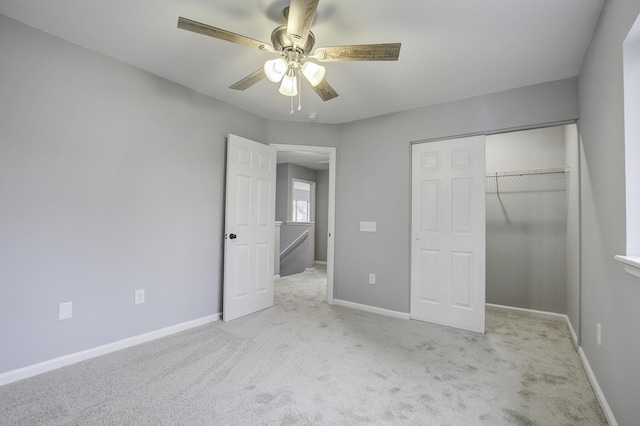 unfurnished bedroom with a closet, light carpet, and ceiling fan