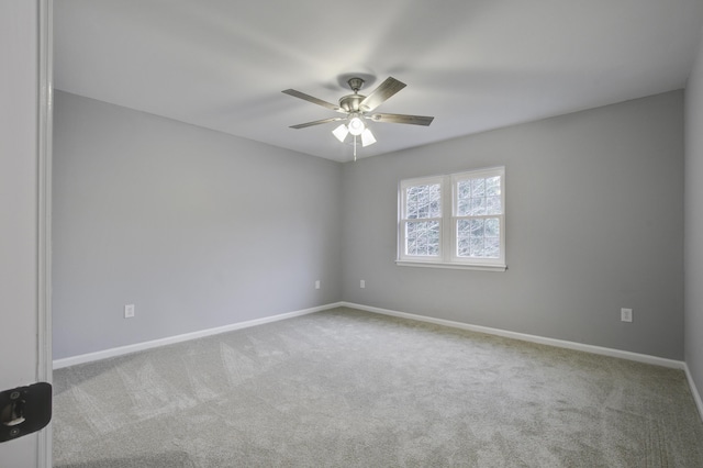 spare room with light carpet and ceiling fan