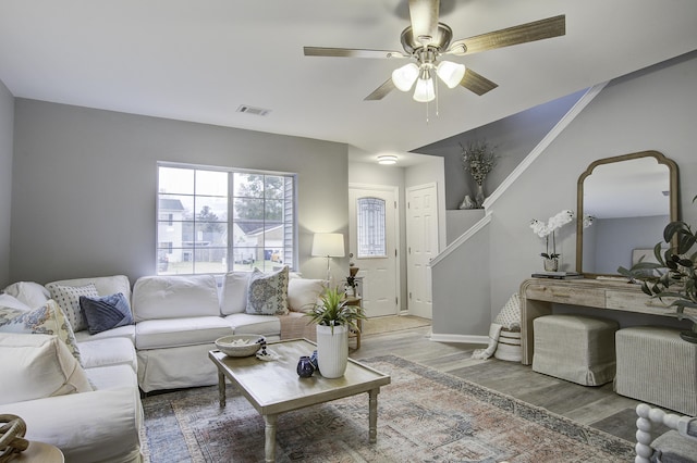 living room with hardwood / wood-style flooring and ceiling fan