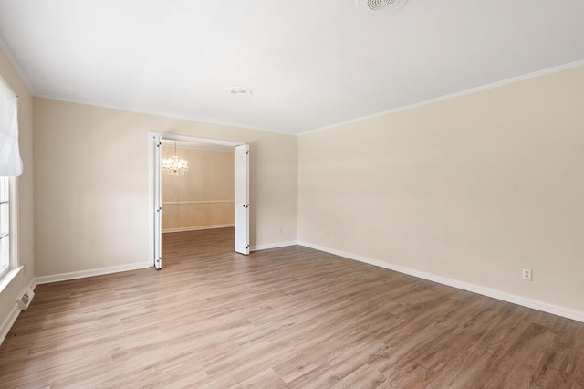 unfurnished room featuring baseboards, light wood-style floors, a chandelier, and crown molding