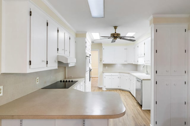 kitchen featuring a sink, ceiling fan, under cabinet range hood, stainless steel dishwasher, and black electric stovetop