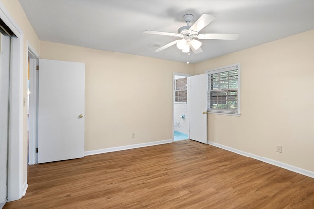 unfurnished bedroom featuring ceiling fan, light wood-type flooring, and baseboards