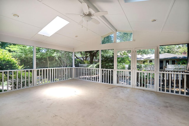 unfurnished sunroom with vaulted ceiling with beams and a ceiling fan