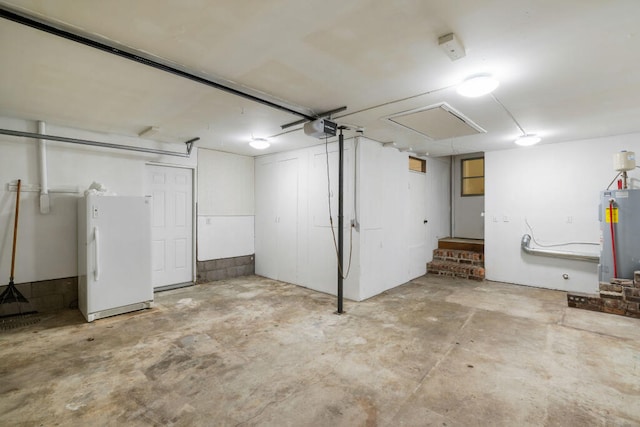 below grade area featuring gas water heater, a garage, and freestanding refrigerator