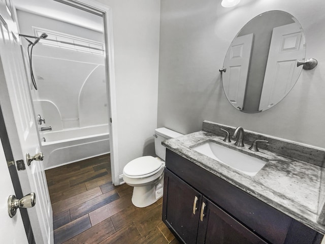 full bathroom with wood finished floors, toilet, vanity, and tub / shower combination