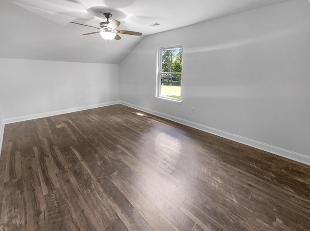 additional living space featuring lofted ceiling, dark wood-style flooring, ceiling fan, and baseboards