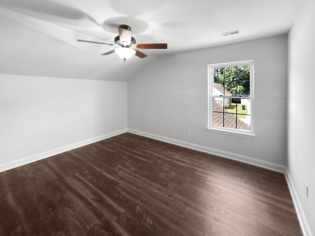 additional living space featuring lofted ceiling, dark wood finished floors, baseboards, and a ceiling fan