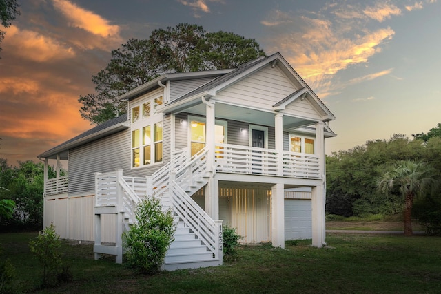 1224 Midvale Ave, Charleston, SC 29412 - view of front of home with stairway, covered porch, an attached garage, and a yard