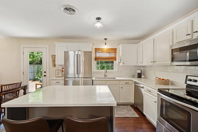 1107 S Shadow Dr, Mount Pleasant, SC 29464 - kitchen with appliances with stainless steel finishes, a sink, decorative backsplash, dark wood-style flooring, and light countertops