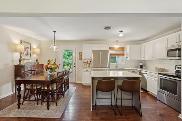 1107 S Shadow Dr, Mount Pleasant, SC 29464 - kitchen with appliances with stainless steel finishes, a sink, white cabinetry, a kitchen island, and light countertops