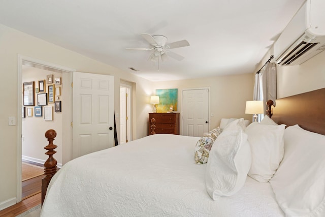1107 S Shadow Dr, Mount Pleasant, SC 29464 - bedroom featuring wood finished floors, an AC wall unit, a ceiling fan, and baseboards