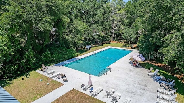 view of swimming pool with a yard and a patio area