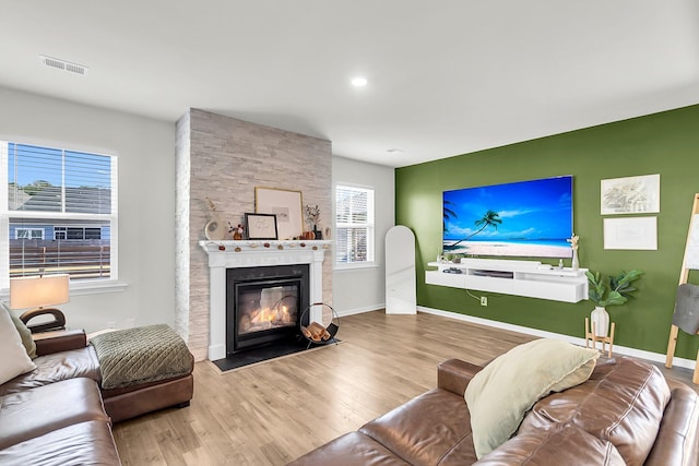 living room with hardwood / wood-style flooring and a fireplace