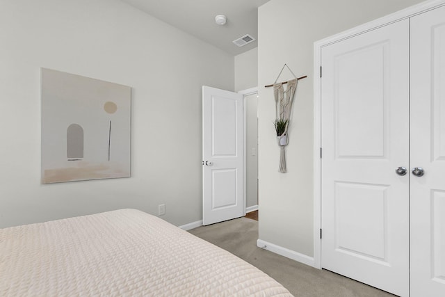 bedroom with carpet and a closet