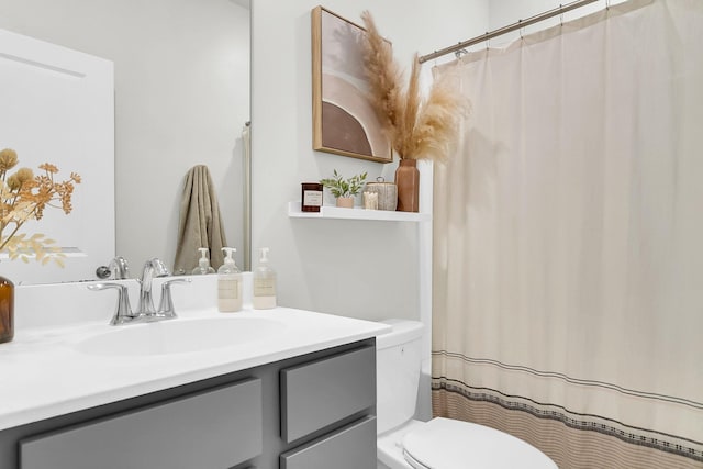 bathroom featuring vanity and toilet