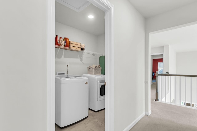 clothes washing area with light colored carpet and independent washer and dryer