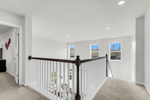 corridor with light colored carpet