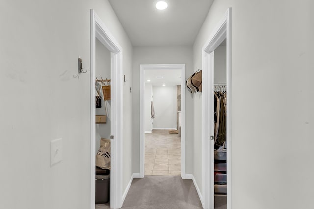 corridor with light colored carpet