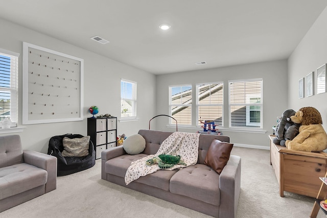 living room featuring light carpet and plenty of natural light